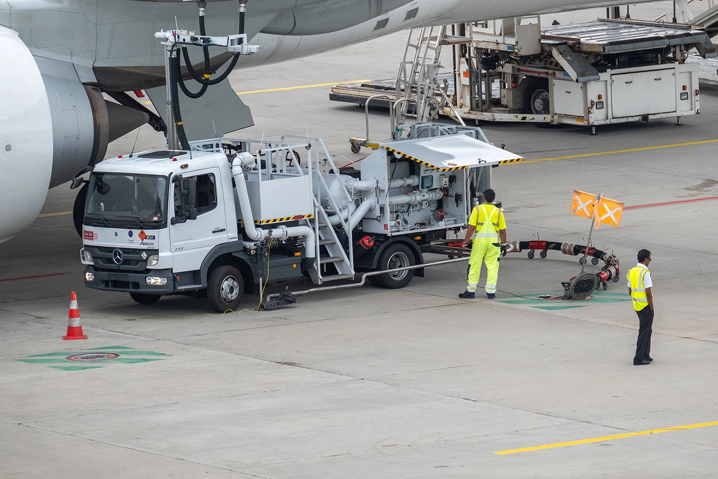 airport employees refueling an aircraft